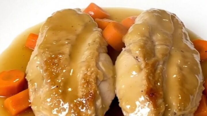 A white plate featuring tender honey ginger chicken breasts topped with glazed carrot coins.