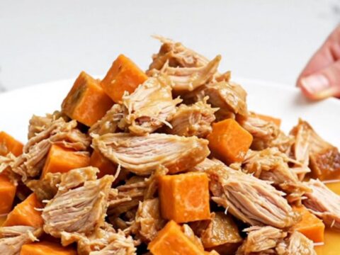 A close-up of a serving of smoky ground turkey and sweet potatoes in a white bowl with steam rising.