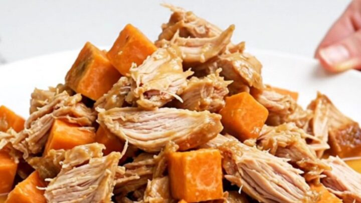 A close-up of a serving of smoky ground turkey and sweet potatoes in a white bowl with steam rising.