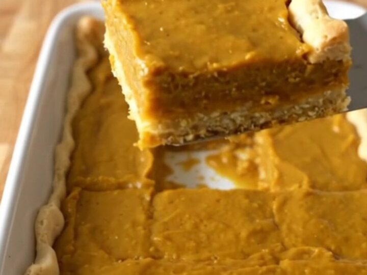 A top-down view of perfectly baked pumpkin pie crescent bars in a rectangular white baking dish.