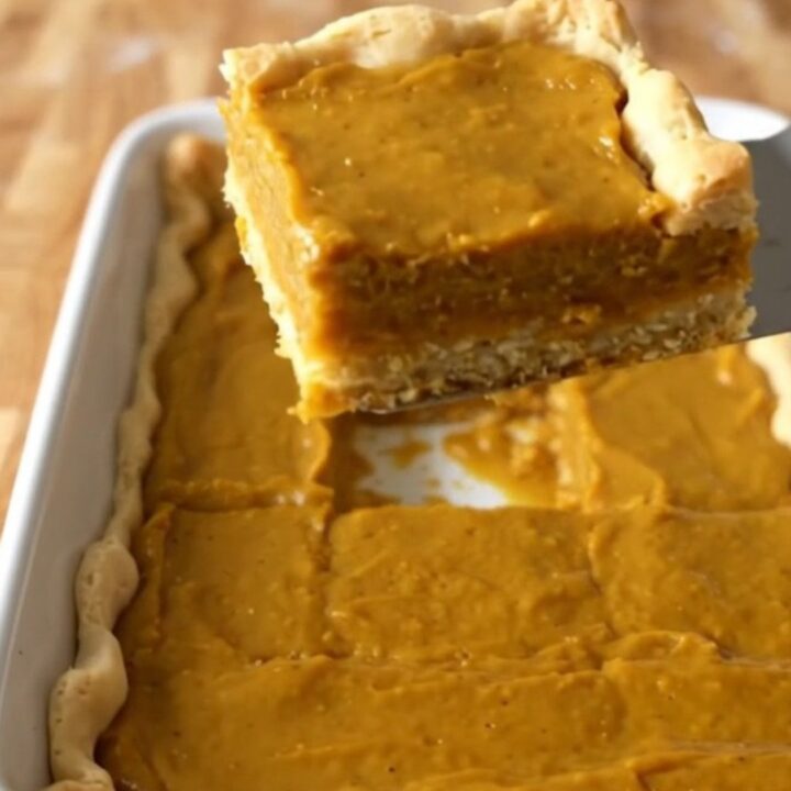 A top-down view of perfectly baked pumpkin pie crescent bars in a rectangular white baking dish.