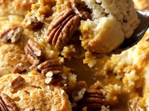 A warm pumpkin spice biscuit bubble bake in a ceramic dish, topped with crunchy pecans and golden-brown biscuits.