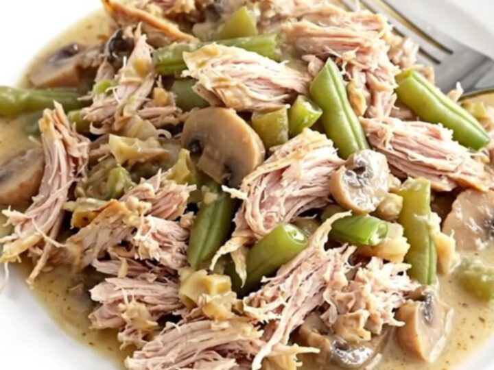 A close-up of the finished turkey and green bean casserole in a slow cooker insert.