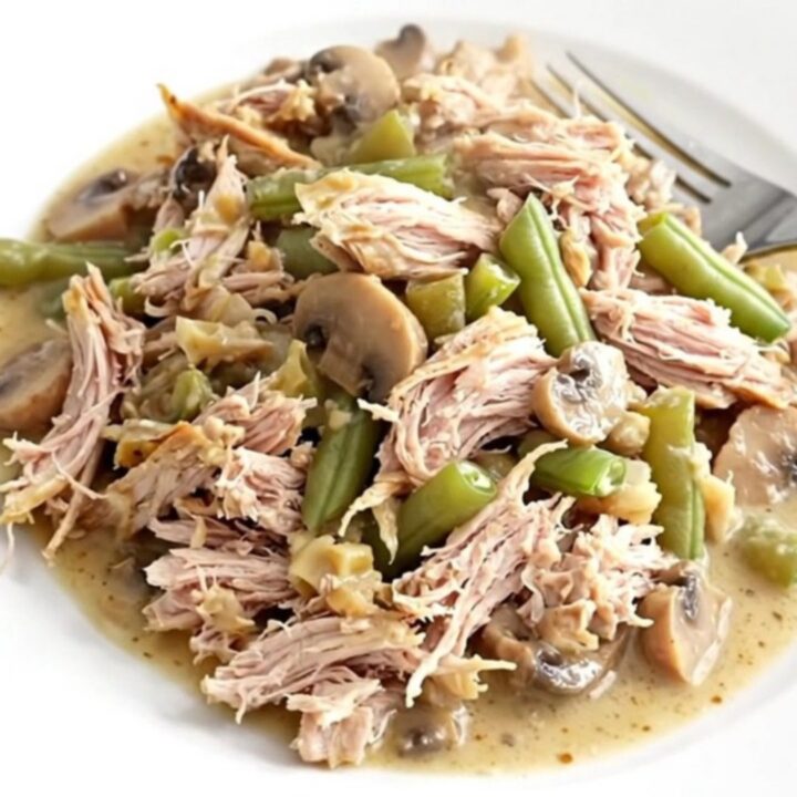 A close-up of the finished turkey and green bean casserole in a slow cooker insert.