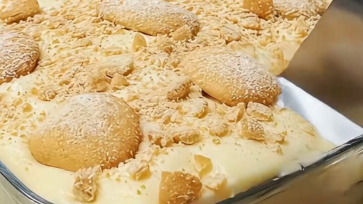A glass baking dish filled with layers of creamy vanilla pudding, sliced bananas, and vanilla wafers.