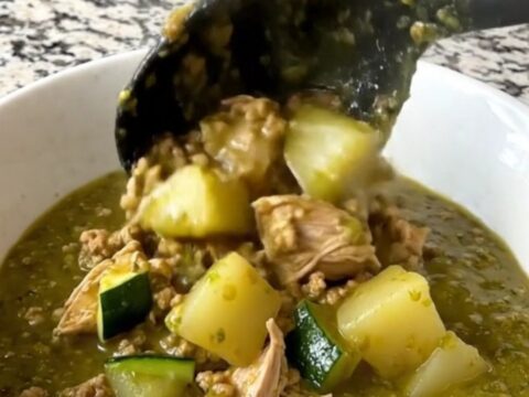 A hearty bowl of slow cooker swamp stew featuring ground turkey, zucchini, and potatoes in a vibrant green salsa verde sauce.