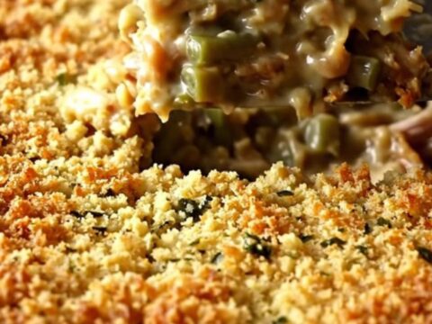 A golden-brown baked turkey and stuffing casserole in a white ceramic dish.
