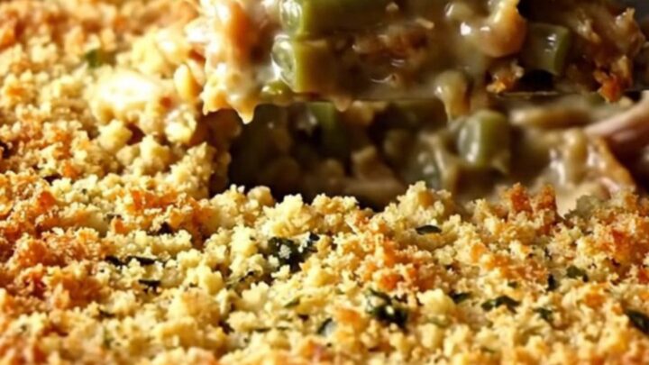 A golden-brown baked turkey and stuffing casserole in a white ceramic dish.