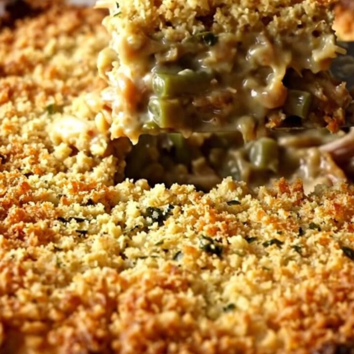 A golden-brown baked turkey and stuffing casserole in a white ceramic dish.