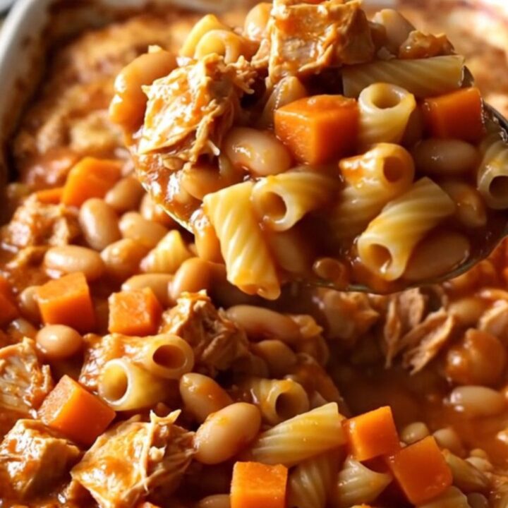 A top-down view of a rectangular ceramic dish filled with a baked pasta, turkey