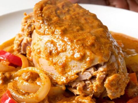 A bowl of creamy turkey paprikash with vibrant red peppers and onions in a rich, paprika-infused sauce.