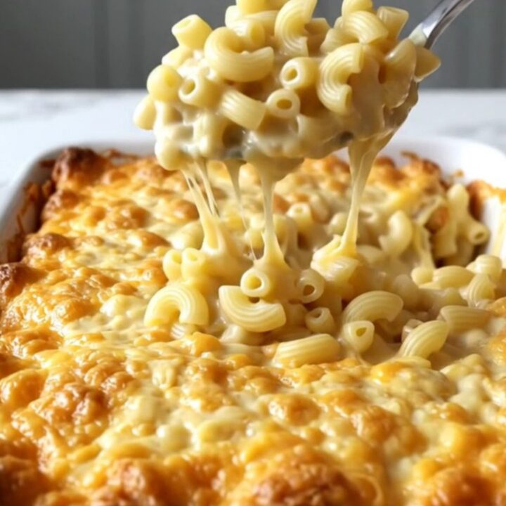 A top-down view of a rectangular baking dish filled with creamy, golden-brown baked macaroni and cheese.