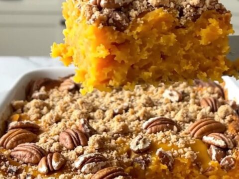 A freshly baked pecan streusel sweet potato casserole in a rectangular ceramic dish, showing a golden brown crust.