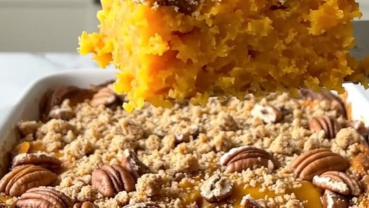 A freshly baked pecan streusel sweet potato casserole in a rectangular ceramic dish, showing a golden brown crust.