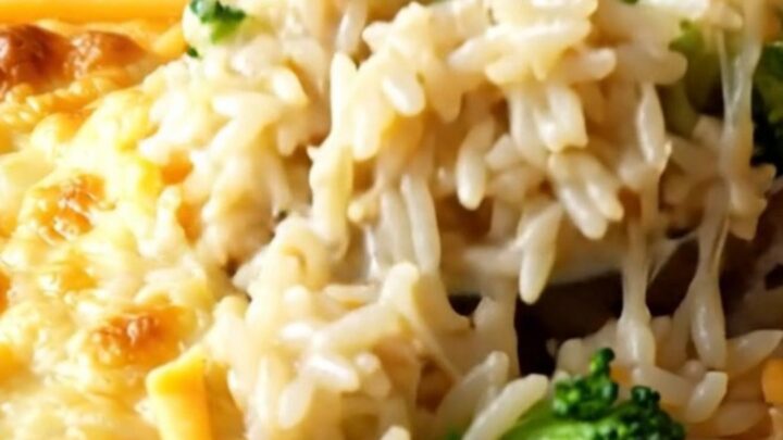 A cheesy broccoli rice casserole in a white baking dish with golden melted cheese on top.