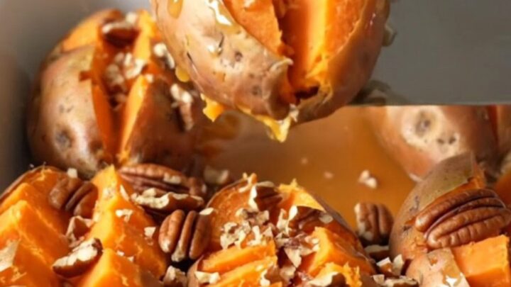 A close-up of baked hasselback sweet potatoes in a white baker