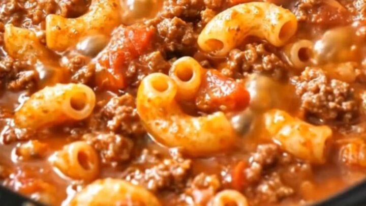 A piping-hot, saucy beef and elbow macaroni skillet glistening under warm light.