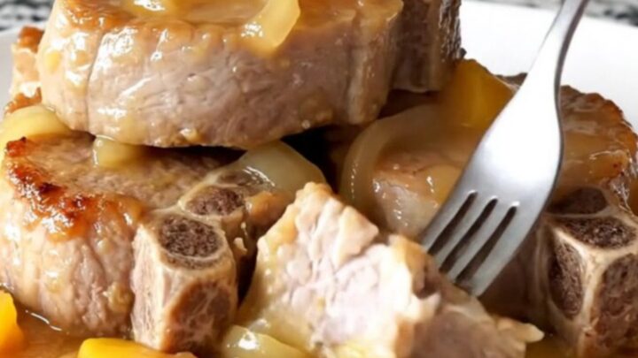 Juicy slow-cooked pork loin slices topped with caramelized peaches and onions in a savory sauce.