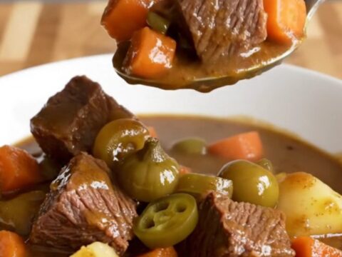 A close-up of a bowl of slow-cooked Mississippi beef stew with tender beef, carrots, and potatoes.