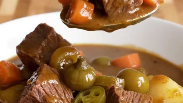 A close-up of a bowl of slow-cooked Mississippi beef stew with tender beef, carrots, and potatoes.