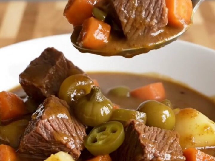 A close-up of a bowl of slow-cooked Mississippi beef stew with tender beef, carrots, and potatoes.