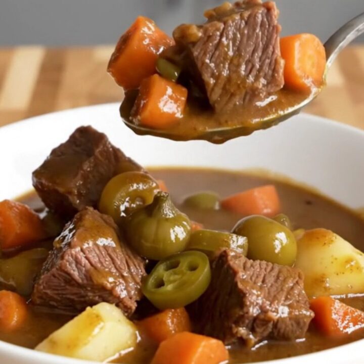 A close-up of a bowl of slow-cooked Mississippi beef stew with tender beef, carrots, and potatoes.