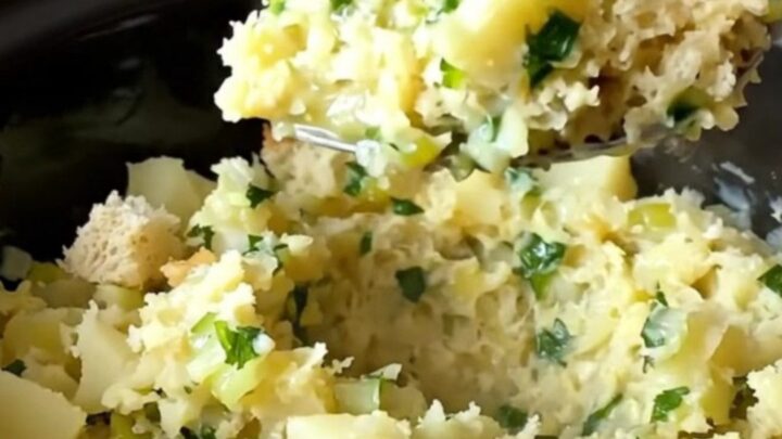 A close-up of creamy, rustic potato filling served in a white bowl with fresh parsley garnish.