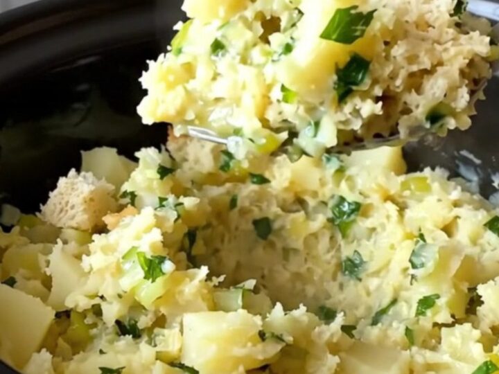 A close-up of creamy, rustic potato filling served in a white bowl with fresh parsley garnish.