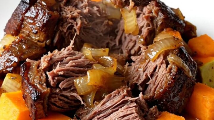 A close-up of a tender chuck roast with butternut squash in a slow cooker, featuring a rich honey balsamic glaze.