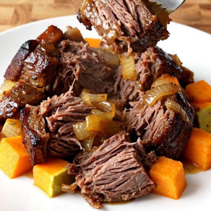 A close-up of a tender chuck roast with butternut squash in a slow cooker, featuring a rich honey balsamic glaze.