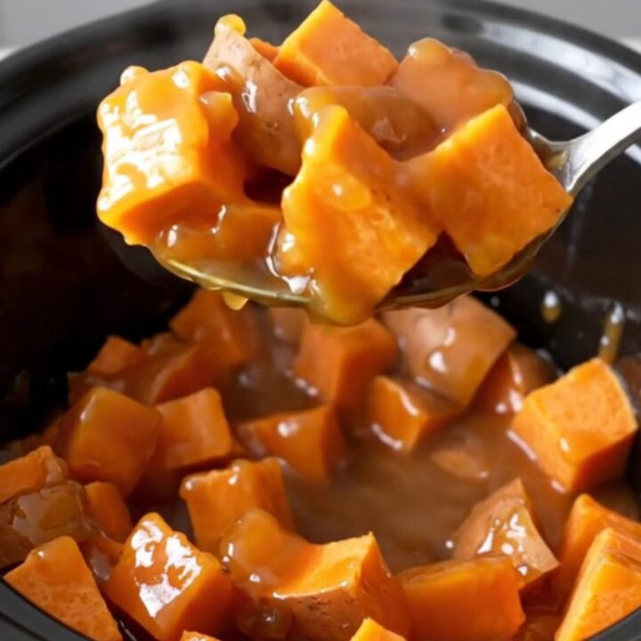 A close-up of tender, bright orange sweet potato chunks mixed with pineapple in a rich