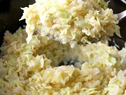 A rustic serving of creamy smashed potatoes mixed with tender cabbage ribbons and green onions.