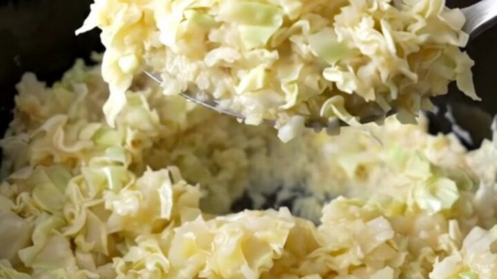 A rustic serving of creamy smashed potatoes mixed with tender cabbage ribbons and green onions.