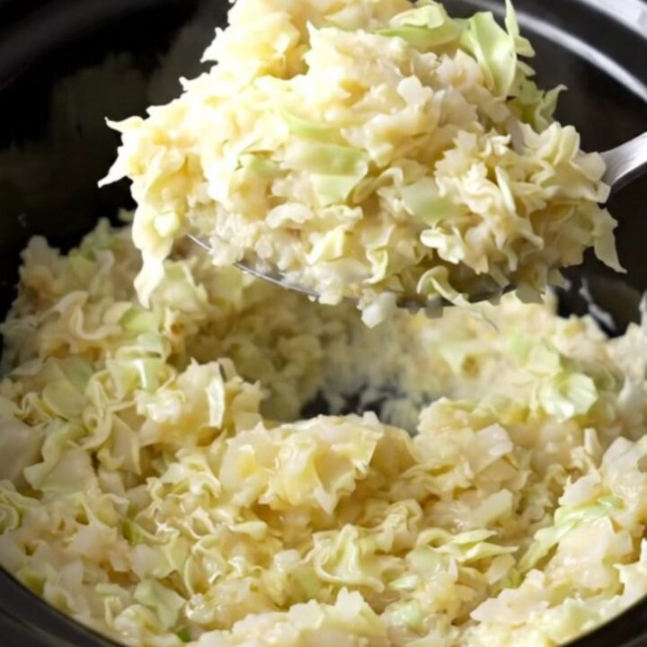 A rustic serving of creamy smashed potatoes mixed with tender cabbage ribbons and green onions.