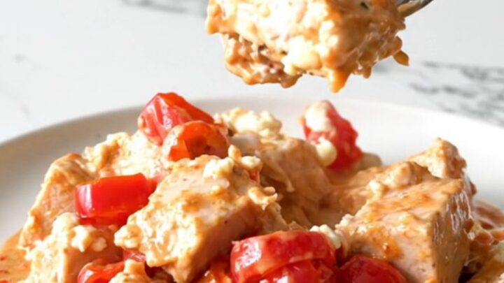 A plate of Utica-style chicken with creamy tomato sauce and cherry peppers.