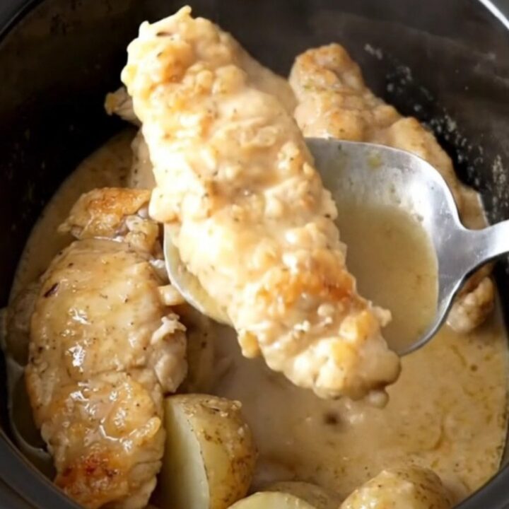 Slow cooker Swedish gravy chicken tenders and potatoes in a black stoneware insert