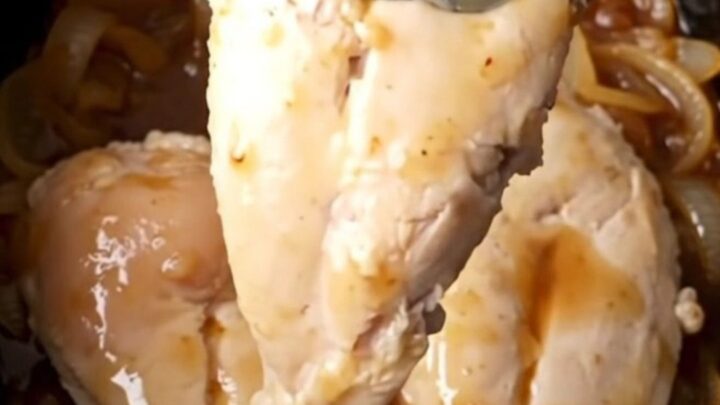 A close-up of tender, golden-tan chicken breasts coated in a thick