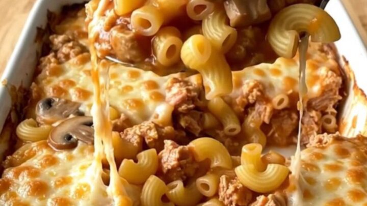 A top-down view of a Johnny Marzetti casserole with ground turkey and macaroni in a white baking dish.