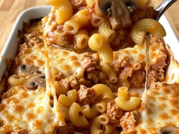 A top-down view of a Johnny Marzetti casserole with ground turkey and macaroni in a white baking dish.