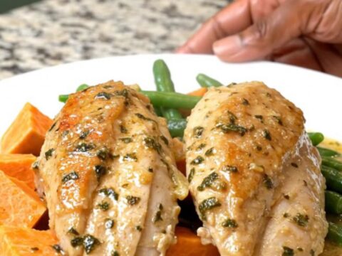 A rustic slow cooker chicken dinner with sweet potatoes and green beans in a creamy herb sauce.