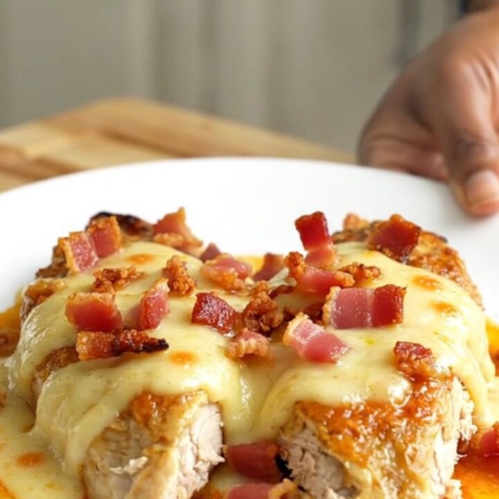 Slow cooked chicken breasts topped with creamy Swiss cheese sauce, bacon, and tomato slices.