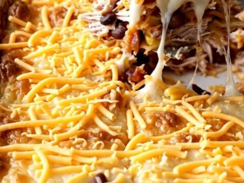 A golden, bubbling ground turkey quesadilla casserole in a white rectangular baker on a beige countertop.