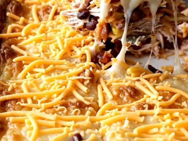A golden, bubbling ground turkey quesadilla casserole in a white rectangular baker on a beige countertop.