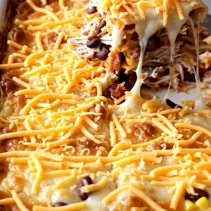 A golden, bubbling ground turkey quesadilla casserole in a white rectangular baker on a beige countertop.