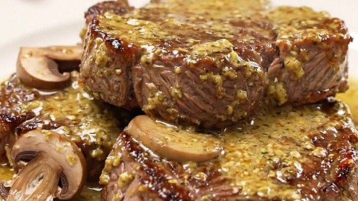 Slow cooker round steak Diane with mushrooms and a rich, creamy Dijon sauce served on a plate.