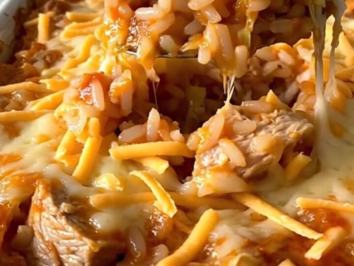 A top-down view of an unstuffed chicken cabbage roll casserole in a white dish, featuring layers of cabbage, rice