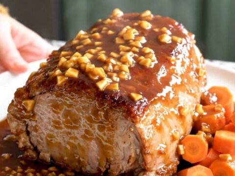 A slow cooker pork loin roast with carrots, glazed in a brown sugar garlic sauce.