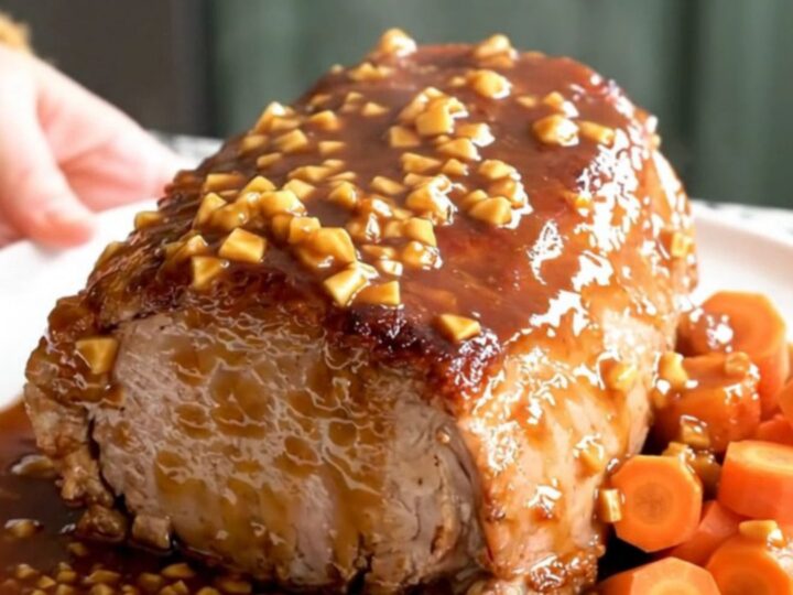 A slow cooker pork loin roast with carrots, glazed in a brown sugar garlic sauce.
