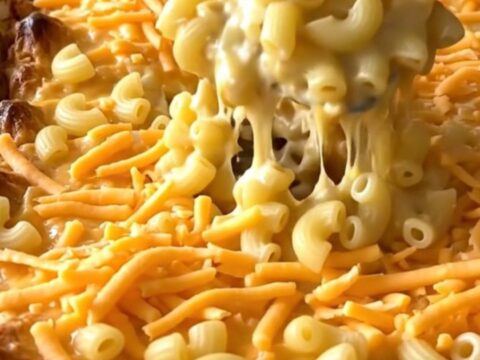 A golden, bubbling creamy cottage cheese mac and cheese bake in a rectangular ceramic dish.
