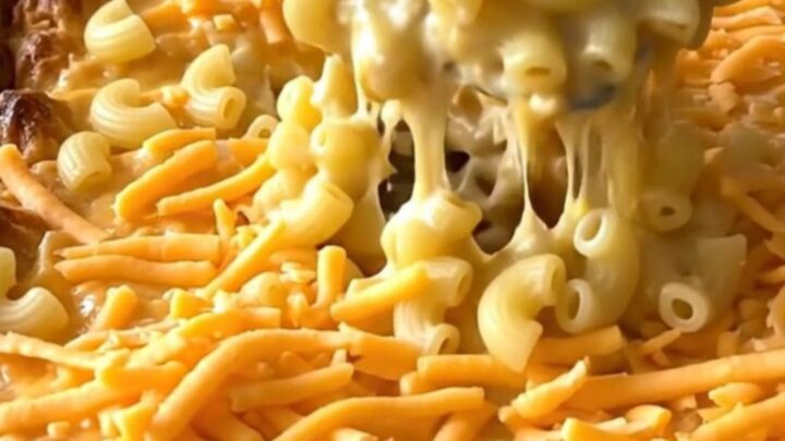 A golden, bubbling creamy cottage cheese mac and cheese bake in a rectangular ceramic dish.